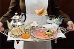 Chambermaid serving luxury breakfast tray