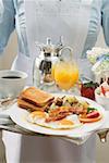 Chambermaid serving breakfast tray