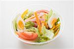 Iceberg lettuce, ham, cheese, egg & tomatoes in plastic bowl