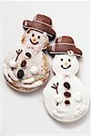 Two gingerbread snowman biscuits