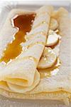 Crêpe with banana slices and caramel sauce