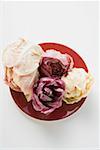 Different types of radicchio on red plate (overhead view)