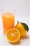 Glass of orange juice and oranges