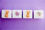 Sugar cubes with Easter decorations in a row