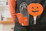 Kitchen tools for Halloween in an apron pocket