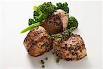 Pork medallions with green peppercorns and broccoli