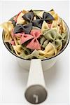 Coloured farfalle in strainer