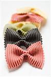 Coloured farfalle in a row