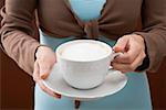 Woman holding cup of cappuccino