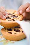 Child's hands holding chocolate tartlet