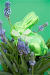 Green Easter Bunny among spring flowers