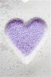 Purple sugar in heart-shaped biscuit mould