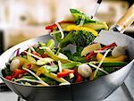 Mixed vegetables in wok and on spatula