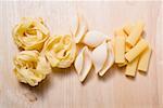 Assorted pasta on wooden background