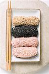 Dumplings coated in sesame seeds & coconut in dish (Japan)