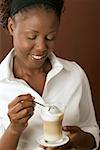 Woman holding a glass of latte macchiato