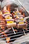 Sausage and pepper kebabs on barbecue