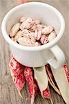 Borlotti beans in cup on bean pods