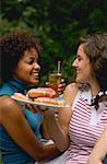 Two women with doughnuts & iced tea on the 4th of July (USA)