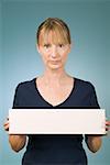 Woman holding a blank sign