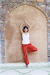 Portrait of a young woman standing in a tree pose