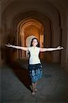 Woman smiling with arms outstretched, Neemrana Fort Palace, Neemrana, Alwar, Rajasthan, India