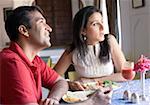 Mid adult couple sitting in a restaurant and smiling