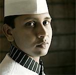 Portrait of a chef in front of a brick wall