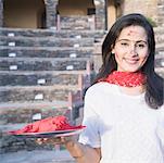 Portrait of a mid adult woman holding a plate of powder paint, Neemrana Fort Palace, Neemrana, Alwar, Rajasthan, India