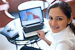 Portrait of a businesswoman sitting in front of a laptop and smiling