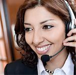 Close-up of a businesswoman wearing a headset and smiling