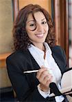 Portrait of a businesswoman holding a pen and smiling