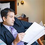 Side profile of a businessman reading a file