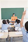 Mid adult woman teaching students in a classroom