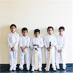 Portrait of five boys standing in a row