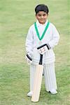 Cricketer standing in a cricket field