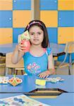 Portrait of a girl holding paper craft products