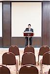 Businessman standing at a lectern