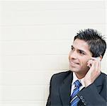 Close-up of a businessman talking on a mobile phone and smiling