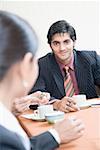 Businesswoman and a businessman discussing in a conference room