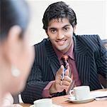 Portrait of a businessman pointing forward and smiling