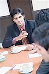 Three business executives discussing in a conference room