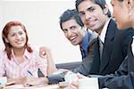 Business executives smiling in a conference room