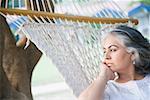 Close-up of a mature woman lying in a hammock