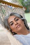 Portrait of a mature woman lying in a hammock