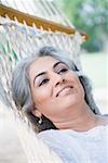 Close-up of a mature woman lying in a hammock