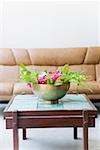 Bowl of flowers on a table in a living room