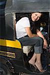 Young woman sitting in a rickshaw