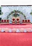 Two armchairs with couches on a wedding stage