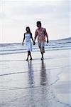 Young couple walking on the beach